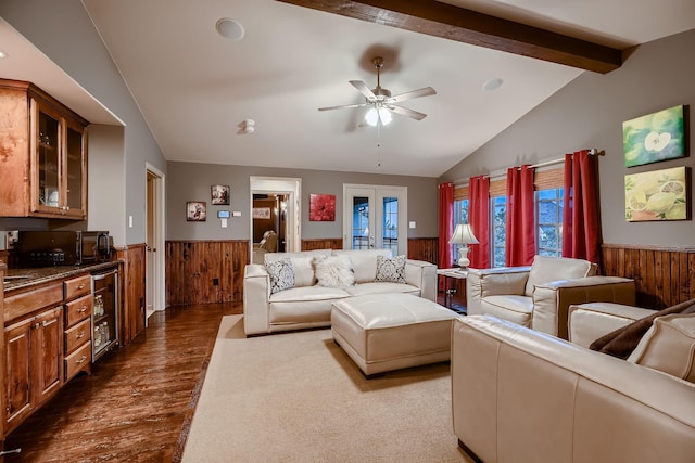 living room with wooden walls, a wainscoted wall, lofted ceiling with beams, and wine cooler