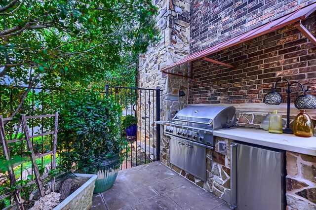 view of patio featuring exterior kitchen and area for grilling