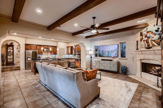 living area with ceiling fan, recessed lighting, beamed ceiling, and light tile patterned floors