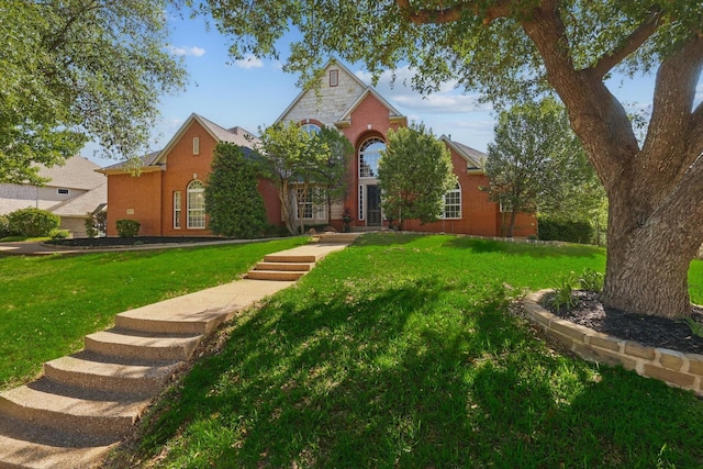 2704 Wisdom Creek Dr, Flower Mound, TX 75022 - traditional-style house featuring a front lawn, brick siding, and stone siding
