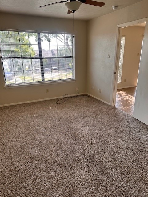 4544 Chaha Rd Unit 103, Garland, TX 75043 - empty room with a ceiling fan, plenty of natural light, a smoke detector, and carpet
