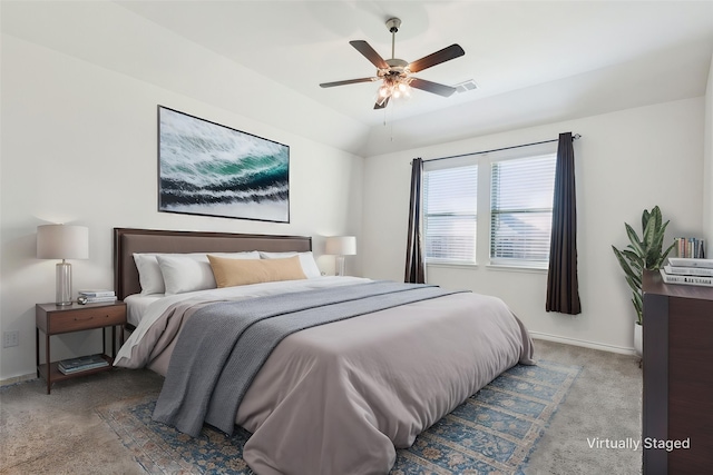 carpeted bedroom with lofted ceiling, visible vents, baseboards, and ceiling fan