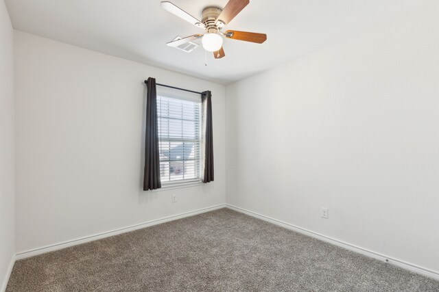 empty room featuring carpet, baseboards, and ceiling fan