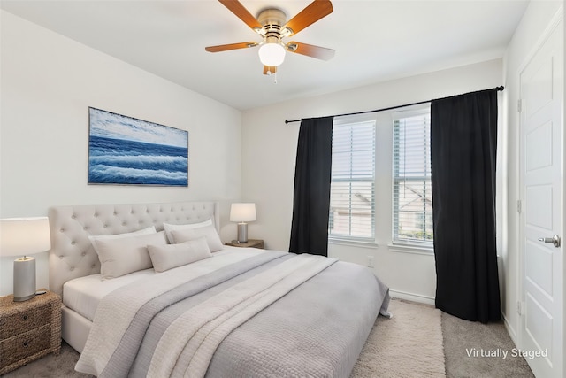 carpeted bedroom featuring baseboards and ceiling fan