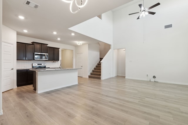 kitchen with a center island with sink, open floor plan, visible vents, recessed lighting, and appliances with stainless steel finishes