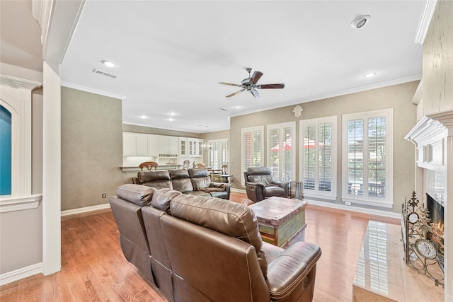 803 Eagle Pass, Heath, TX 75032 - living room featuring a warm lit fireplace, a ceiling fan, light wood finished floors, baseboards, and recessed lighting