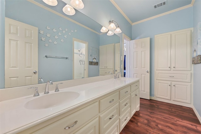 803 Eagle Pass, Heath, TX 75032 - bathroom with double vanity, ornamental molding, a shower, and wood finished floors