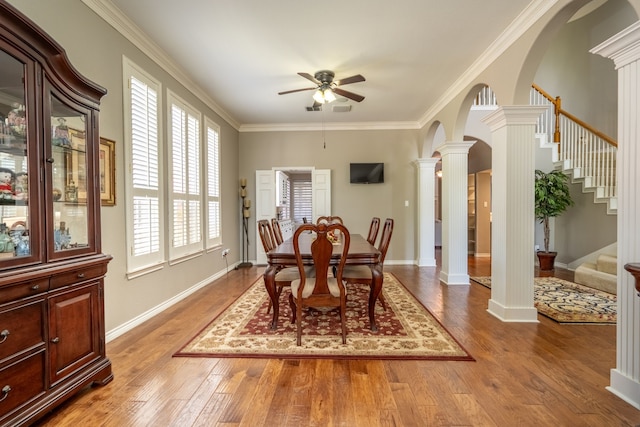 1609 Willow Ln, Mckinney, TX 75072 - dining area with arched walkways, wood finished floors, stairway, ornate columns, and a ceiling fan