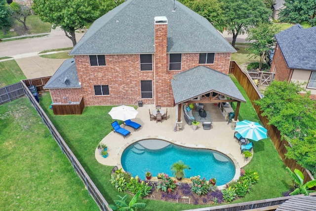 1609 Willow Ln, Mckinney, TX 75072 - rear view of property with brick siding, a yard, a fenced backyard, and roof with shingles