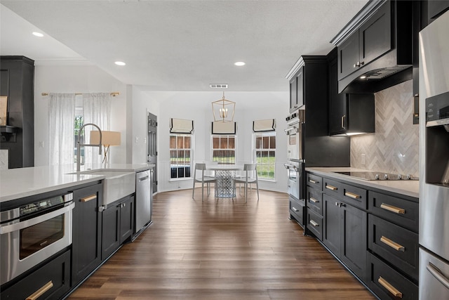 kitchen featuring light countertops, backsplash, visible vents, and stainless steel appliances
