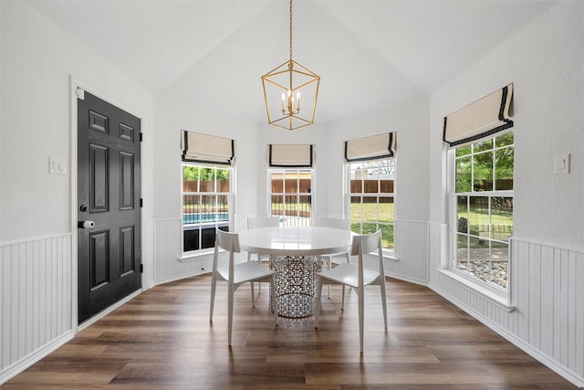dining room with wainscoting, lofted ceiling, a chandelier, and dark wood-style floors