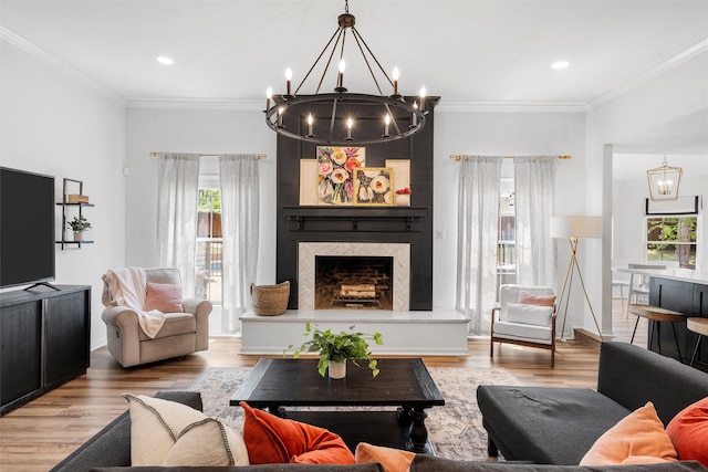 living area featuring a notable chandelier, wood finished floors, and a healthy amount of sunlight