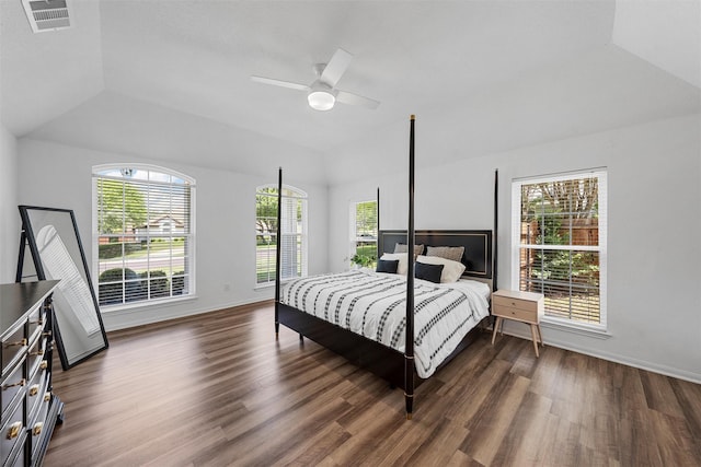 bedroom with dark wood finished floors, vaulted ceiling, visible vents, baseboards, and ceiling fan