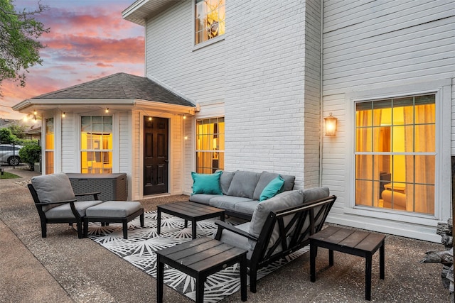 patio terrace at dusk featuring outdoor lounge area