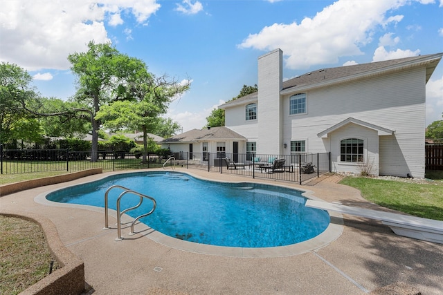 view of swimming pool featuring fence, a patio area, and a fenced in pool