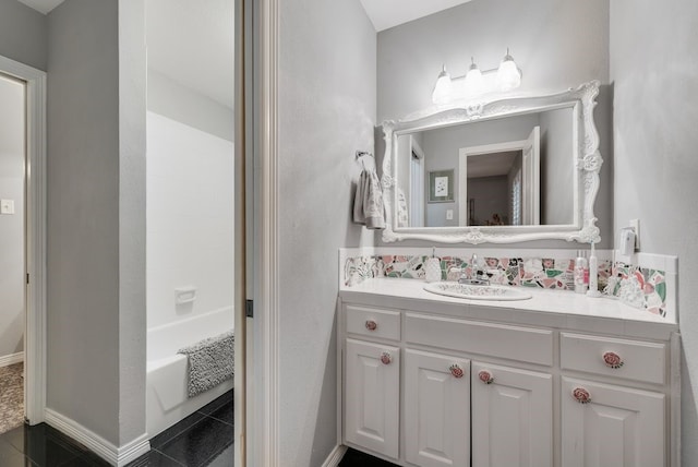 full bath featuring baseboards, shower / bath combination, and vanity