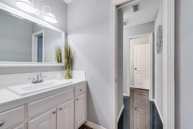 bathroom featuring granite finish floor, visible vents, vanity, and baseboards