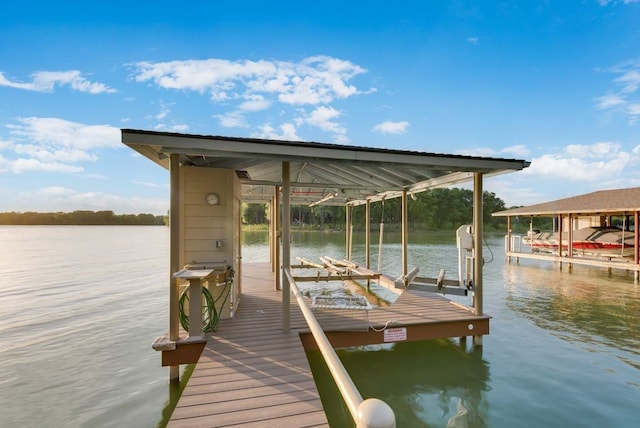 dock area with boat lift and a water view
