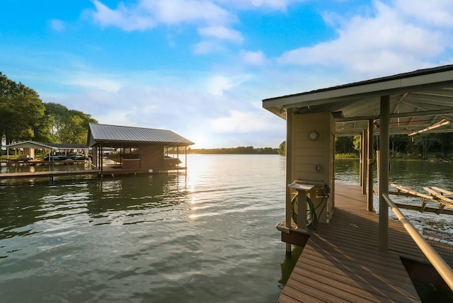 dock area with boat lift and a water view