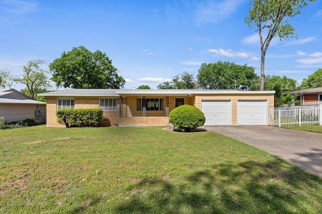 ranch-style house with fence, driveway, brick siding, a front yard, and a garage