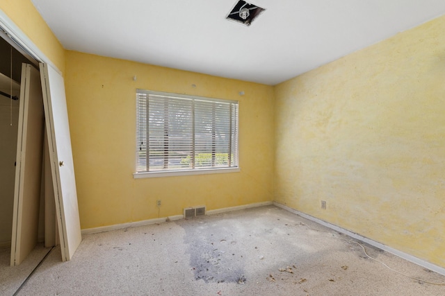 unfurnished bedroom with baseboards, visible vents, and a closet