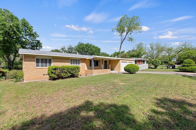ranch-style house featuring brick siding, an attached garage, a front yard, and concrete driveway