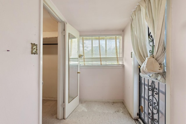 hallway featuring baseboards