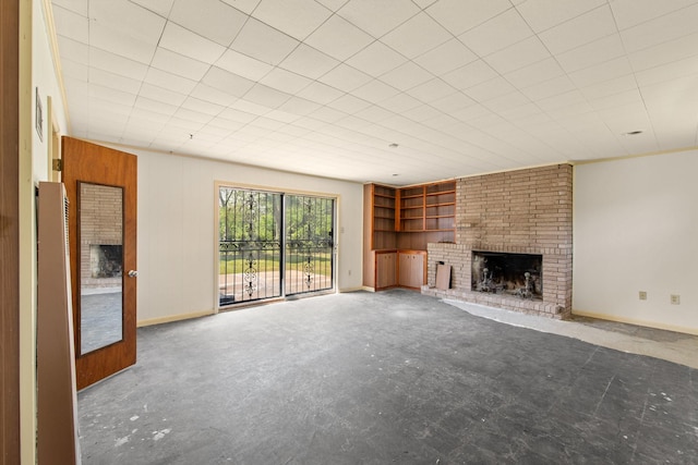 unfurnished living room featuring baseboards, a fireplace, and built in features