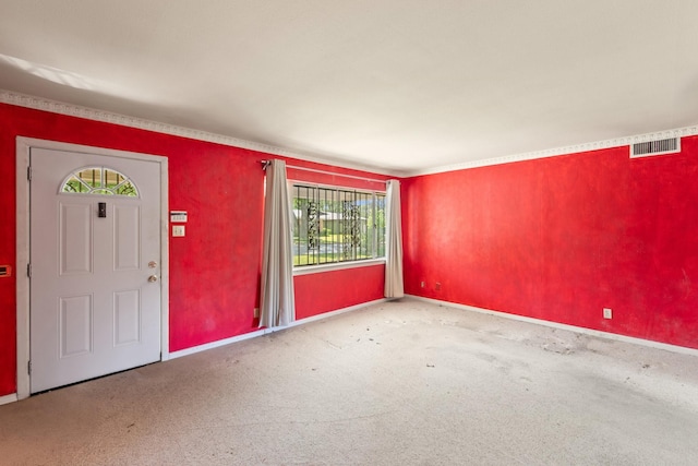 entryway featuring baseboards, carpet flooring, and visible vents
