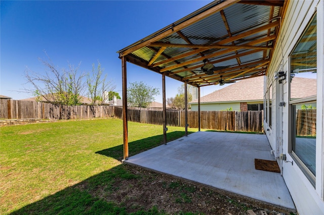 view of yard with a fenced backyard, a ceiling fan, and a patio