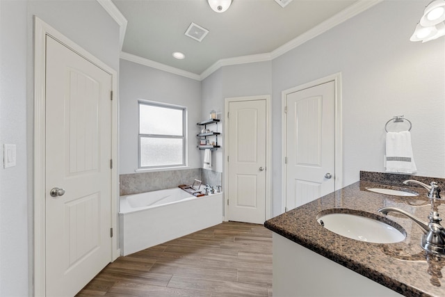 full bath with a bath, visible vents, a sink, and ornamental molding