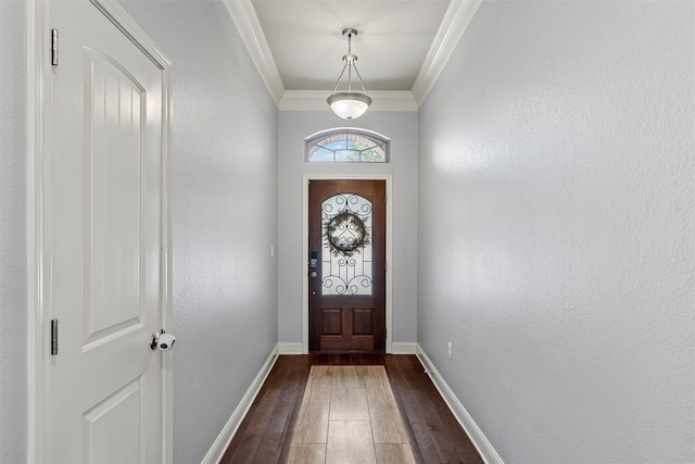 doorway with baseboards, crown molding, and dark wood-type flooring