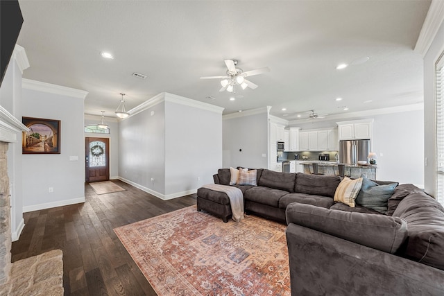 living area with baseboards, dark wood-style floors, ceiling fan, and crown molding