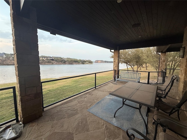 view of patio / terrace with outdoor dining area and a water view