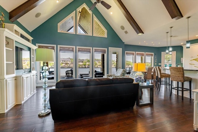 living area featuring high vaulted ceiling, dark wood-style floors, ceiling fan, and beamed ceiling