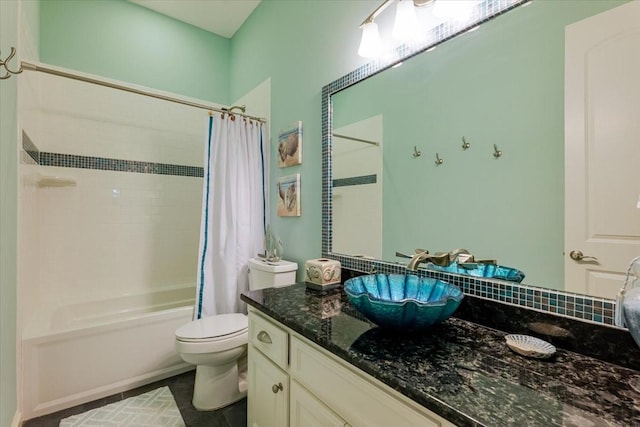 bathroom featuring tile patterned floors, shower / bath combo, vanity, and toilet
