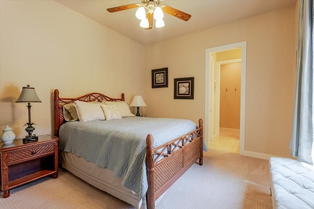 bedroom featuring light carpet, baseboards, and ceiling fan