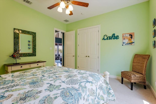 bedroom with a ceiling fan, visible vents, carpet floors, and a closet