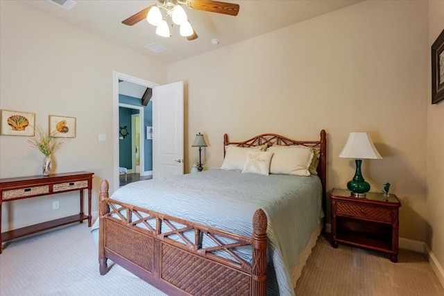 carpeted bedroom with visible vents, a ceiling fan, and baseboards