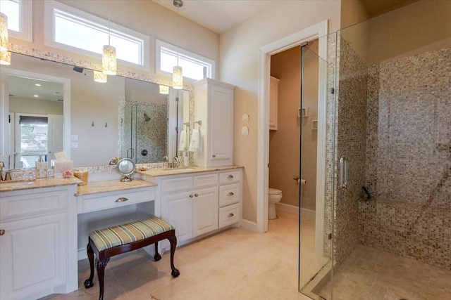 full bath with tile patterned flooring, toilet, vanity, and a stall shower