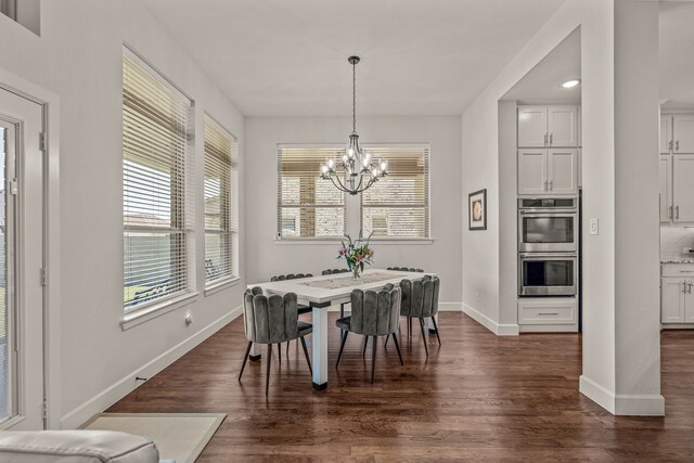 dining area with dark wood-type flooring, baseboards, a chandelier, and a healthy amount of sunlight