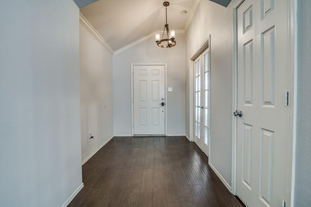 entrance foyer with dark wood-style flooring, vaulted ceiling, baseboards, a chandelier, and crown molding