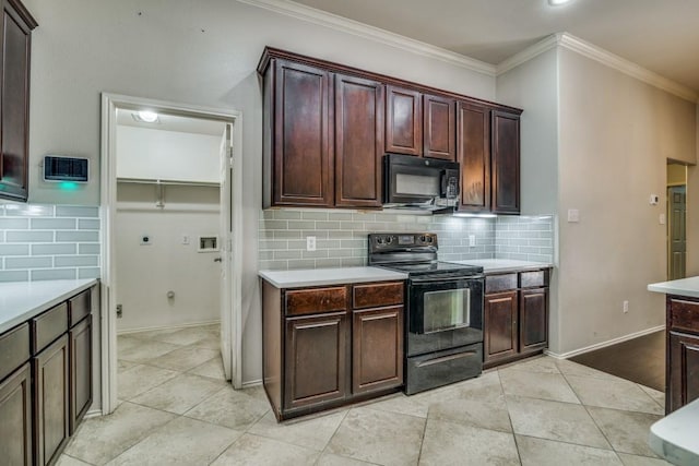 kitchen with light countertops, tasteful backsplash, crown molding, and black appliances