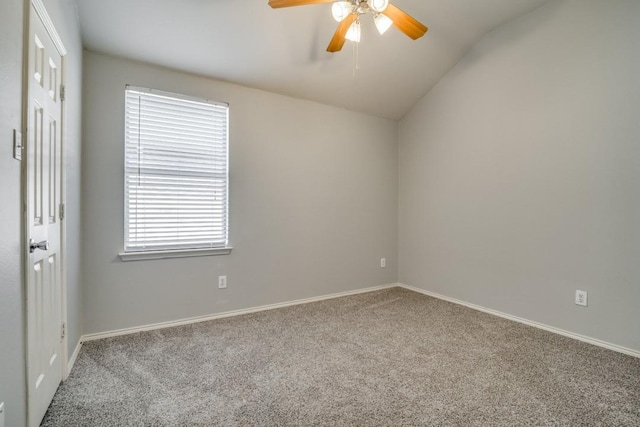 carpeted empty room featuring lofted ceiling, baseboards, and ceiling fan