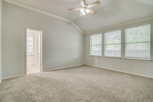 unfurnished room featuring light carpet, vaulted ceiling, baseboards, ceiling fan, and crown molding
