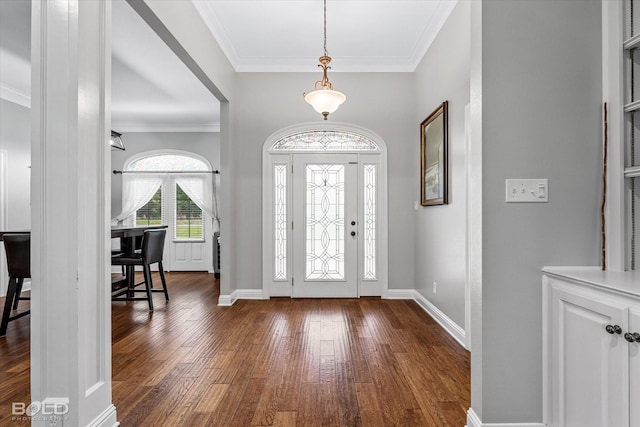 foyer featuring baseboards, dark wood-style floors, and ornamental molding