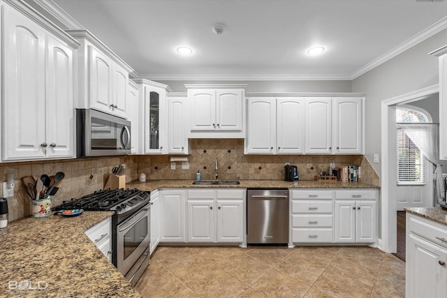kitchen with light stone countertops, stainless steel appliances, a sink, and crown molding