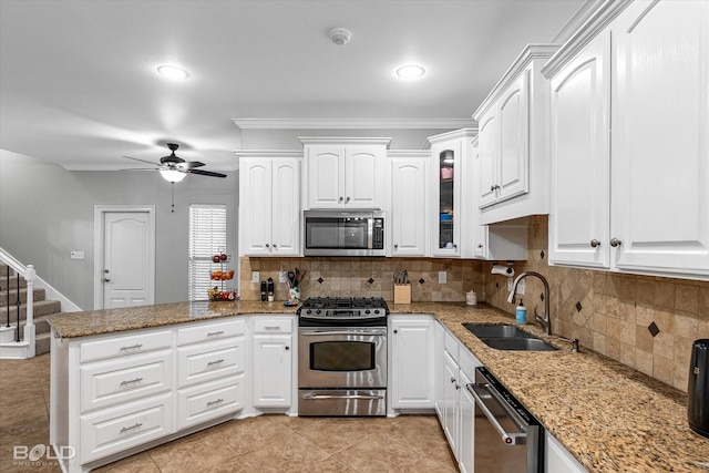 kitchen with a sink, ceiling fan, white cabinetry, a peninsula, and appliances with stainless steel finishes