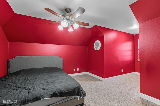 carpeted bedroom with ceiling fan, vaulted ceiling, and baseboards