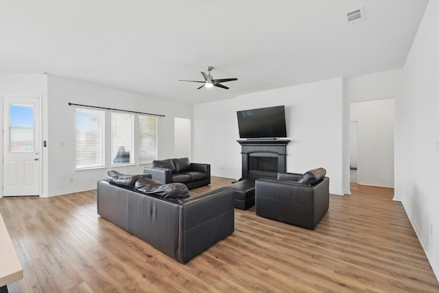 3120 Bent Creek Dr, Anna, TX 75409 - living room featuring ceiling fan, light wood-style floors, a fireplace, and baseboards